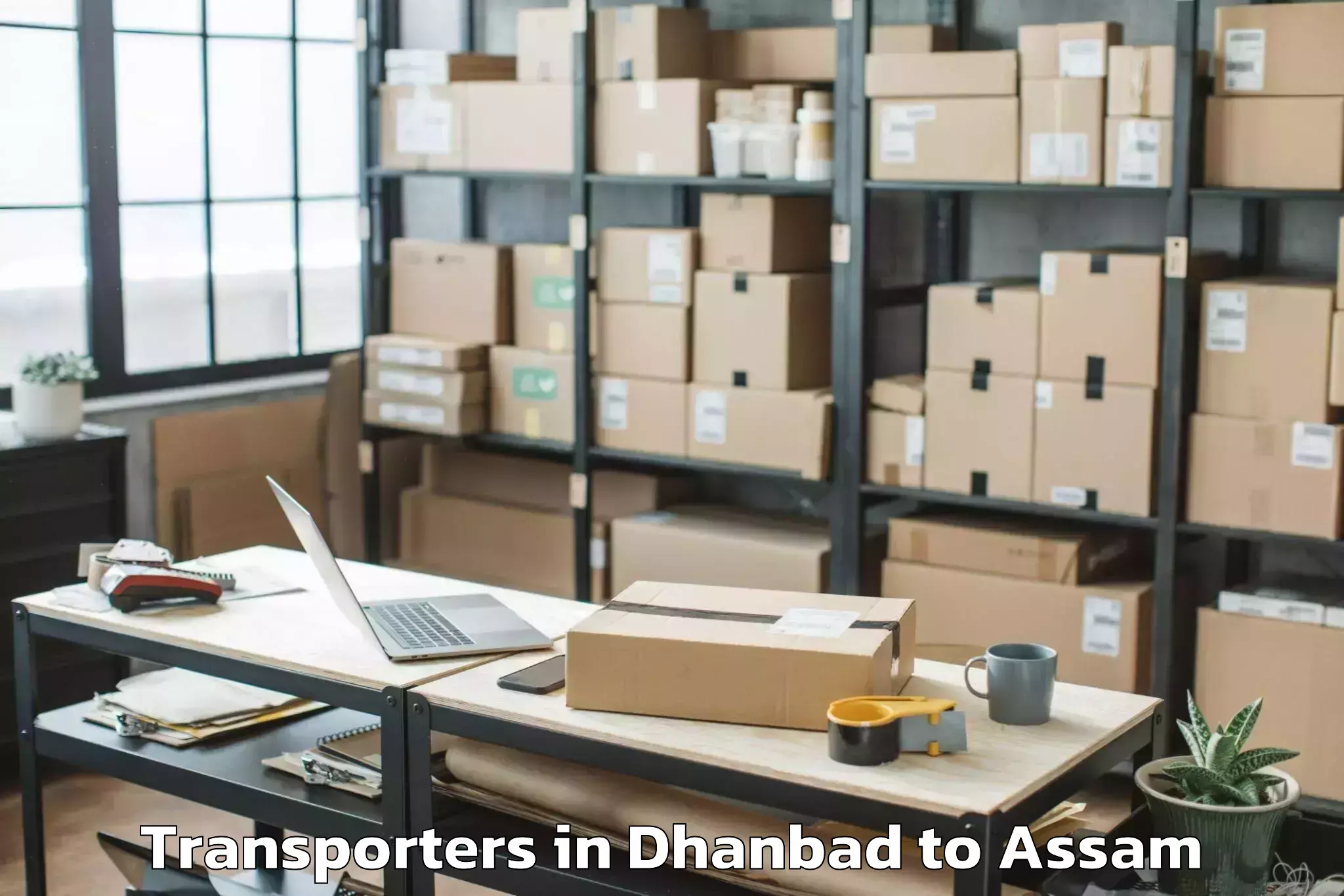 Book Dhanbad to Dhakuakhana Pt Transporters Online